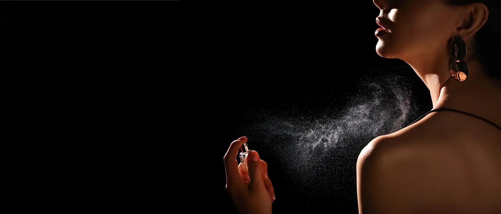 Images of lady spraying perfume on her body